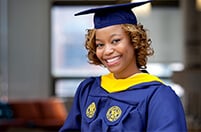 Female Drexel graduate wearing cap and gown