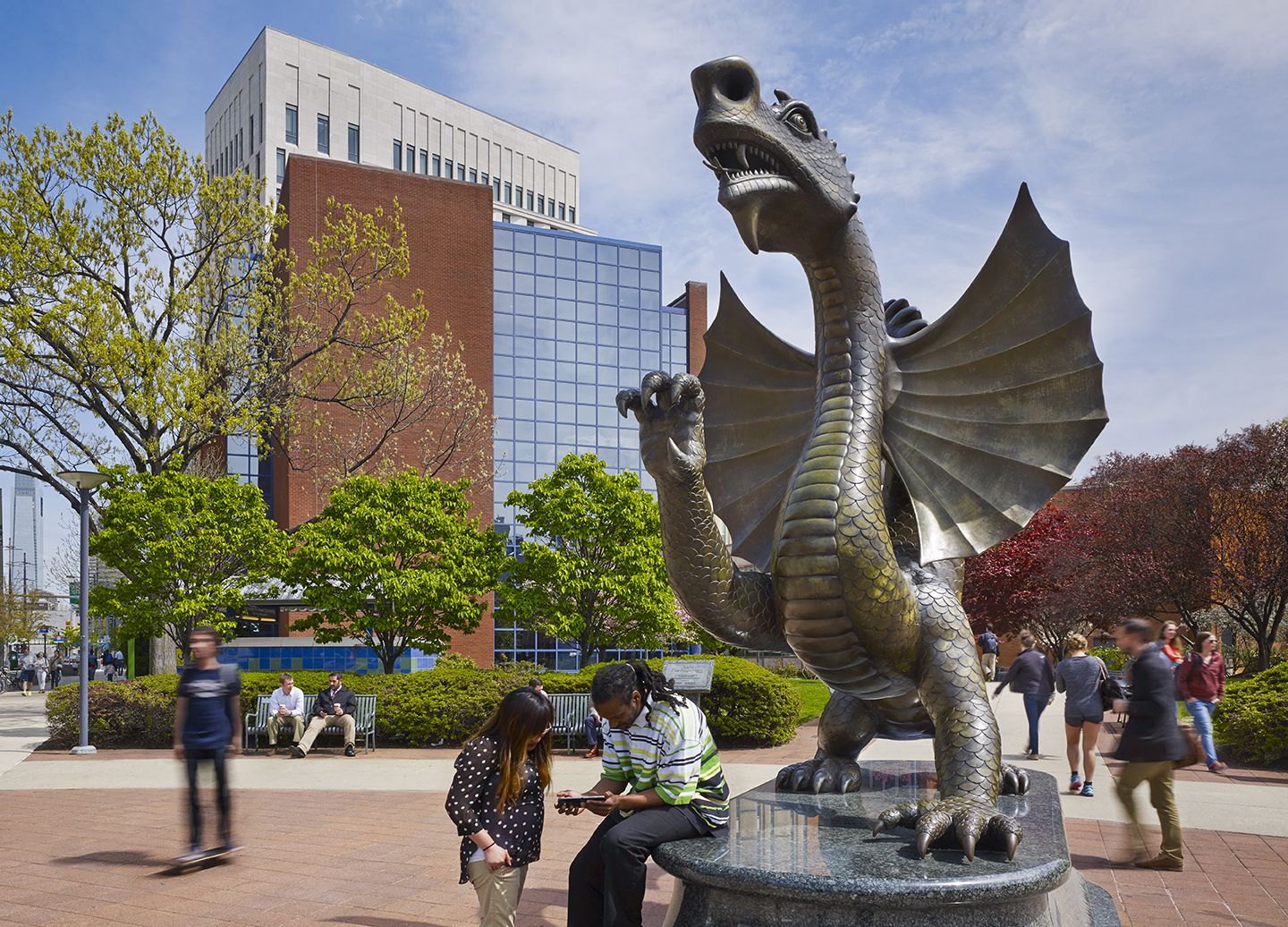 Students walking next to the dragon statue at Drexel University.