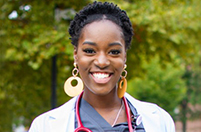 Nurse in scrubs standing outside
